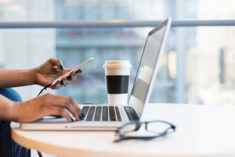 Person on a laptop submitting a CV for healthcare and social care jobs